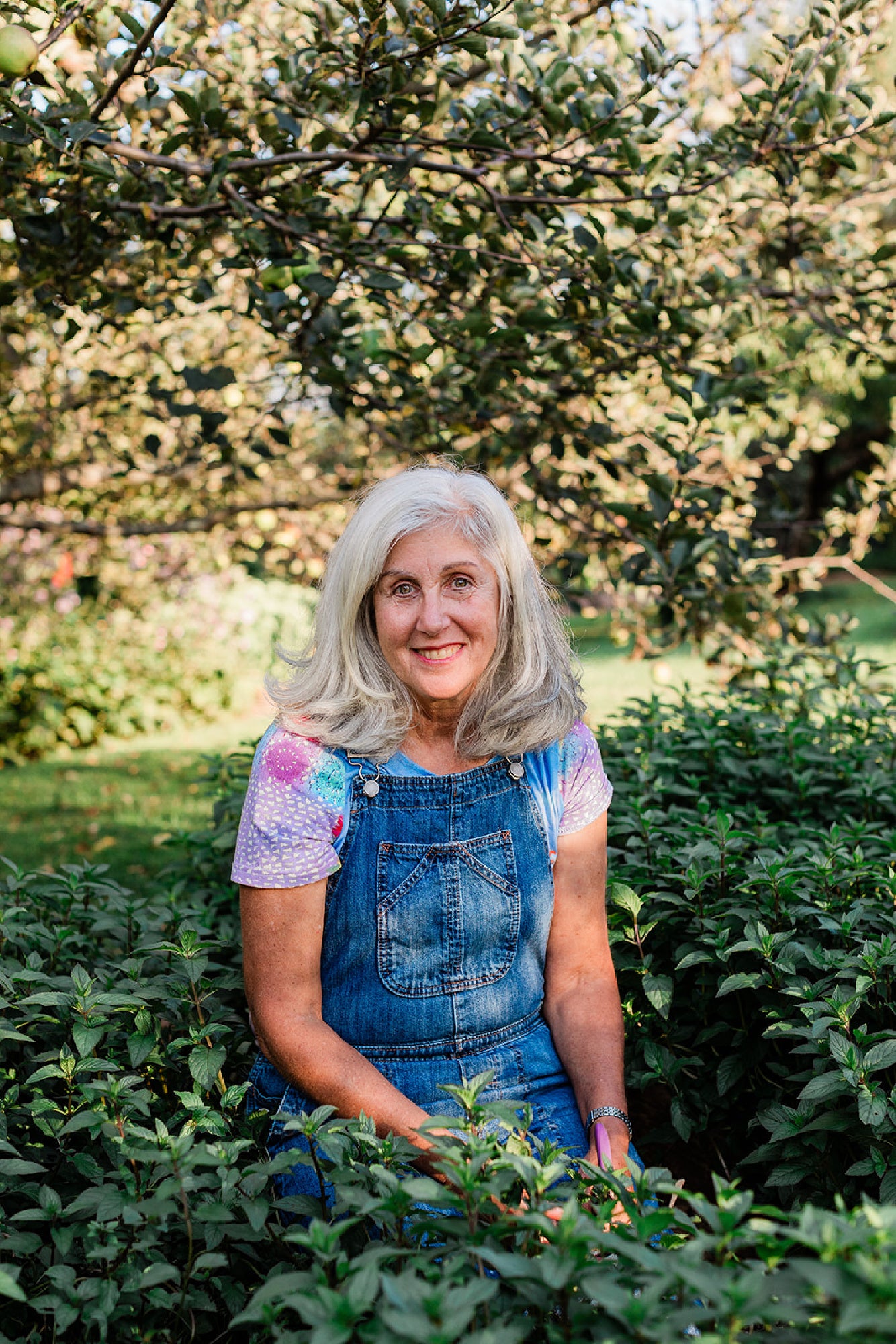 Anna, founder of The Naked Botanical, pictured with farm-fresh, USA grown herbs used in organic herbal teas and wellness products