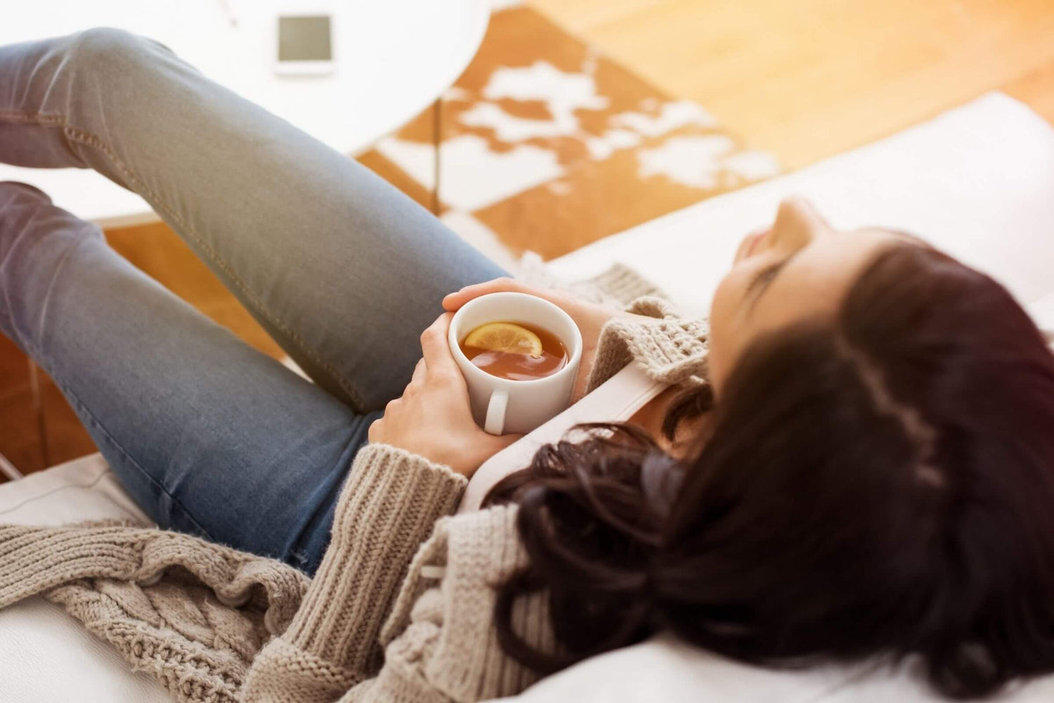 Young woman relaxing with tea.
